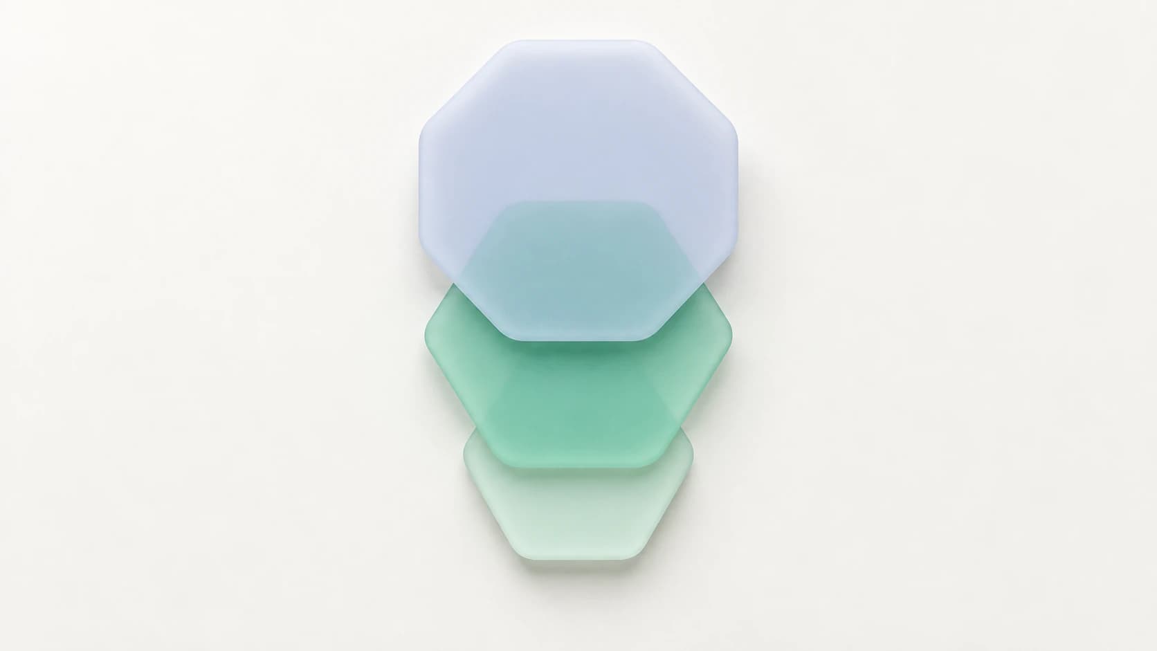 A cascade of rounded matte tiles: a lavender octagon above a pale mint hexagon and a smaller mint polygon