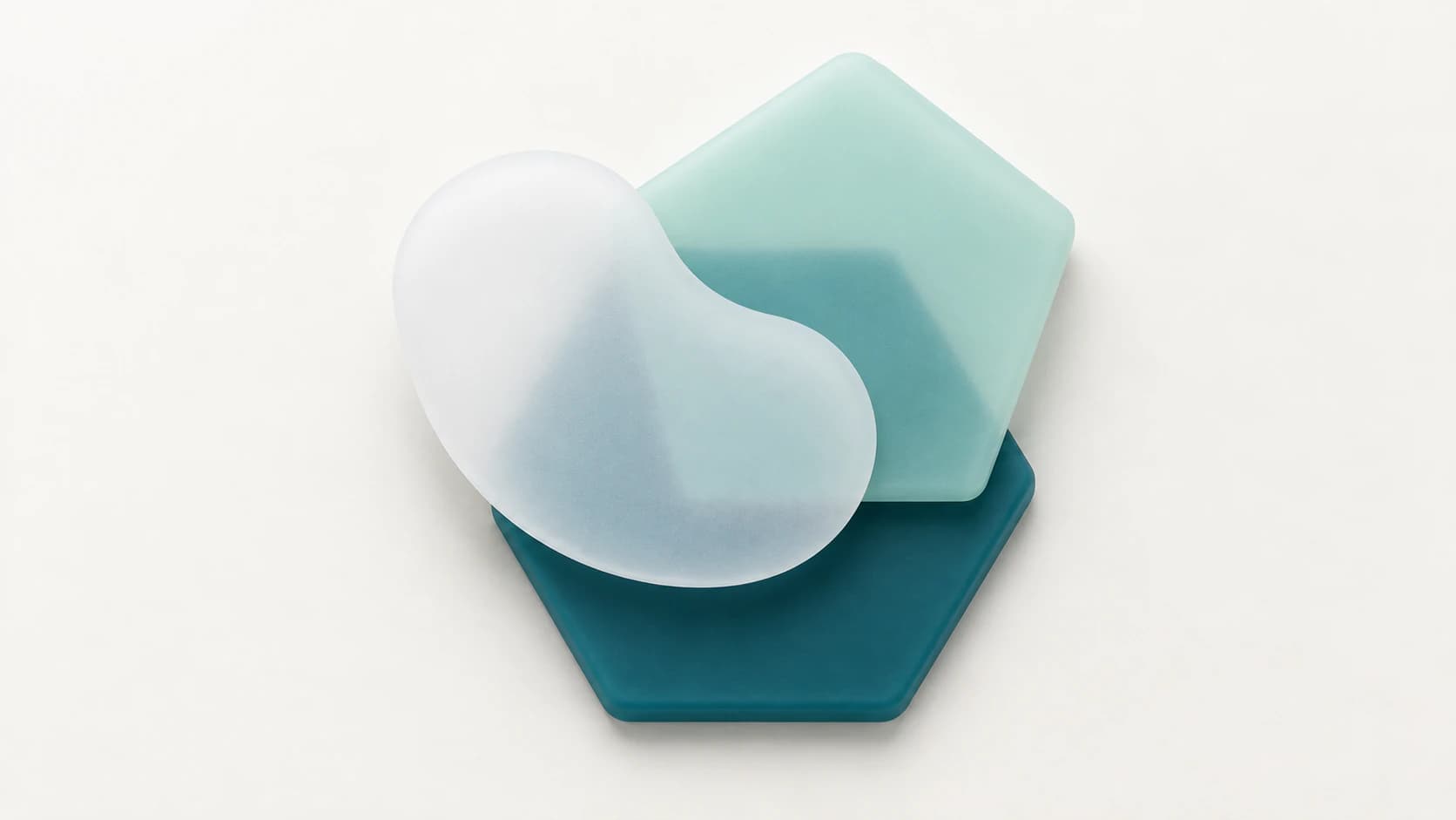 Layered teal and mint rubber polygons beneath a cloudy white organic shape