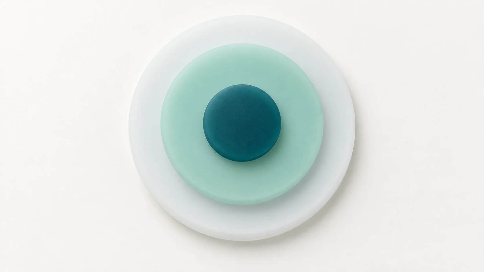 Three concentric matte silicone discs in white, mint and teal